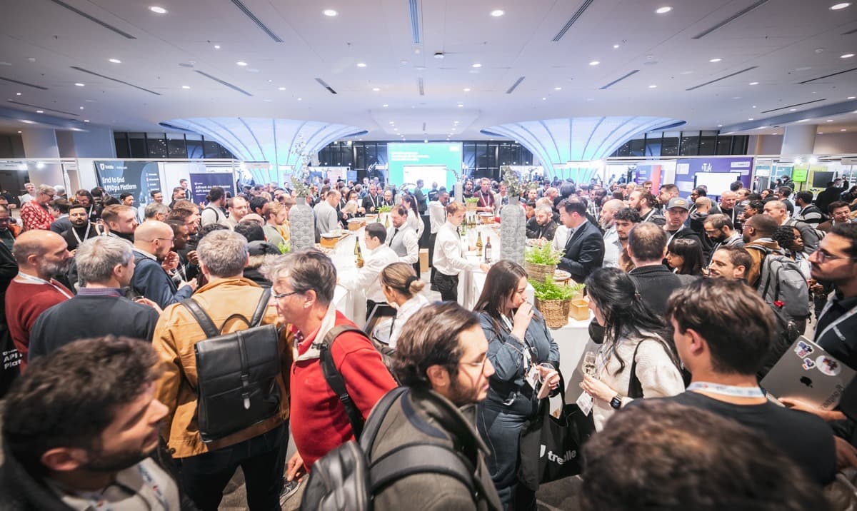 Attendees networking in the expo hall at a Cloud Native AI Summit event